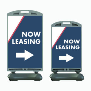 A pair of signs that say " now leasing ".