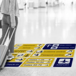 A person with luggage standing in an airport.